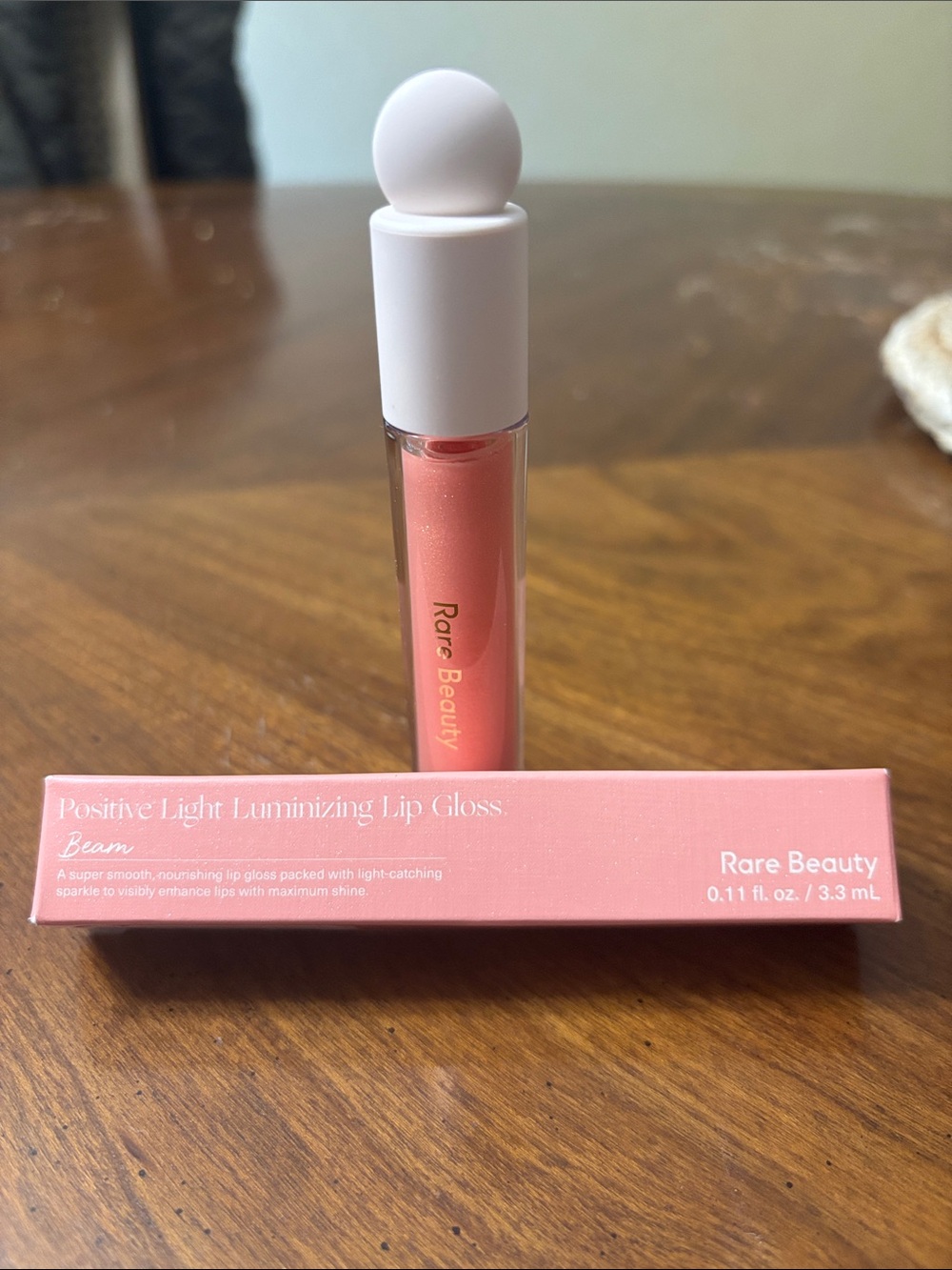 Rare Beauty Positive Light Luminizing Lip Gloss in Beam - Peachy Pink Shimmer